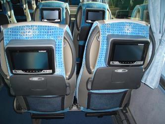 Bus interior showing entertainment system in seat back