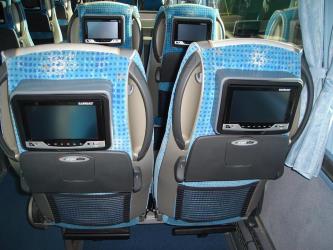 Bus interior showing entertainment system in seat back Bus interior showing entertainment system in seat back