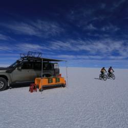 Car, camping and bicycles on field