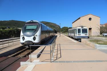 A modern and an older train at the station